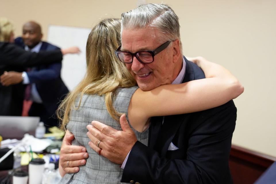 Alec Baldwin hugs a member of his legal team after the judge threw out the involuntary manslaughter case (AP)